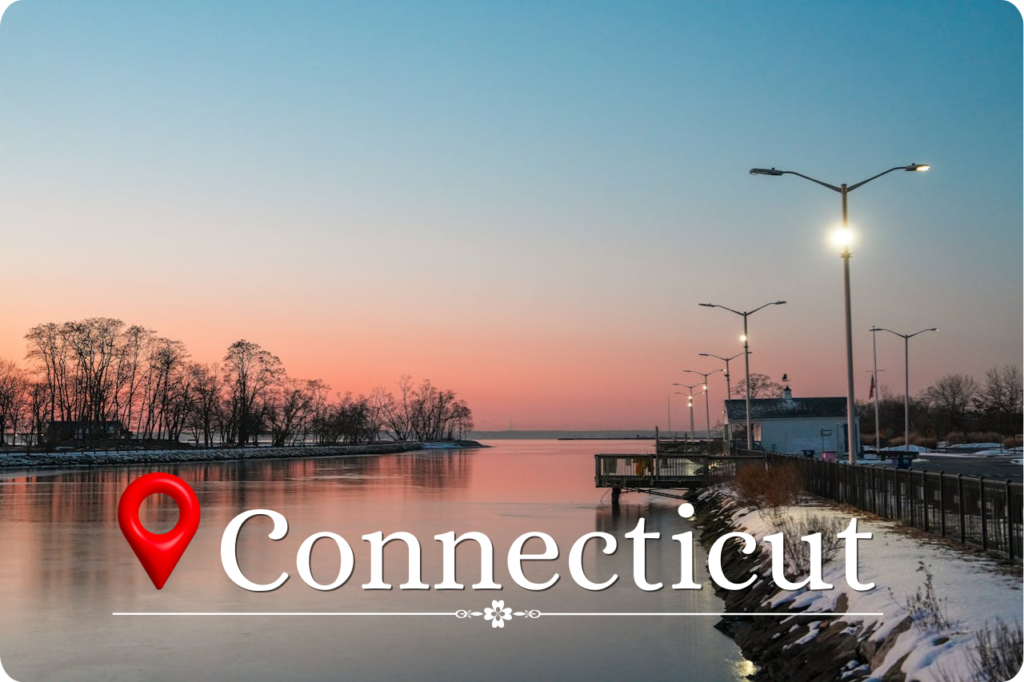 Connecticut Getaway featuring a tranquil waterfront at sunset with calm waters, soft pastel skies, and a quiet harbor promenade