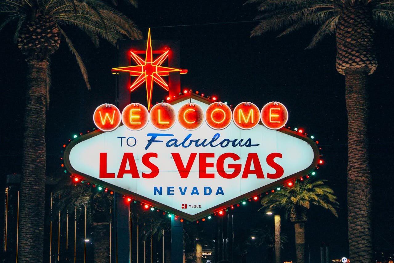 The iconic "Welcome to Fabulous Las Vegas Nevada" sign against a blue sky.